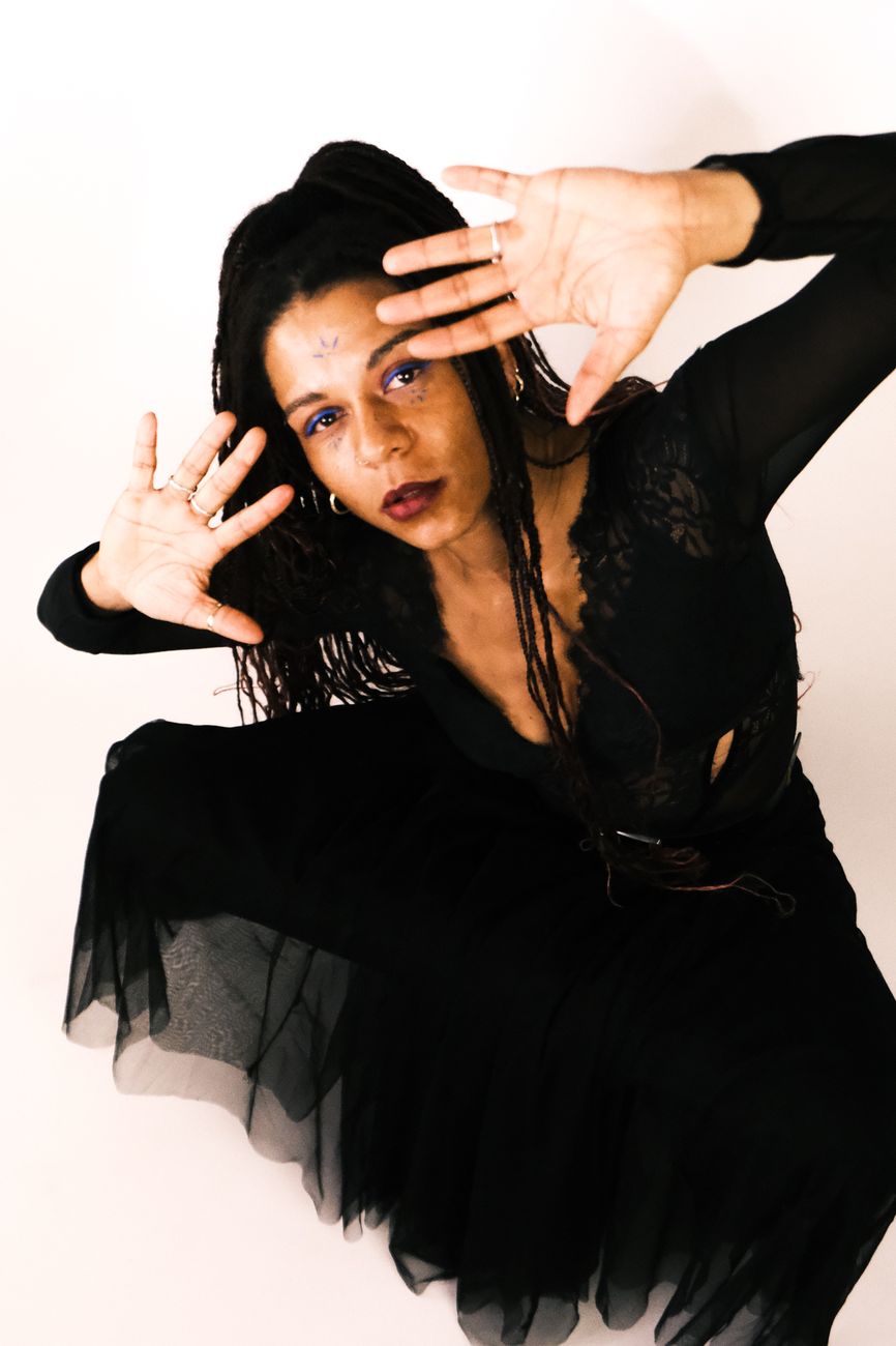 Studio dance pose in flowing black fabric