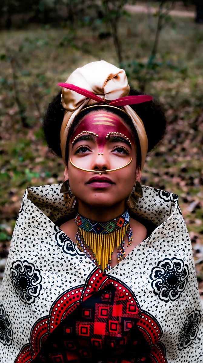 Patterned jacket and headwrap with gold jewellery