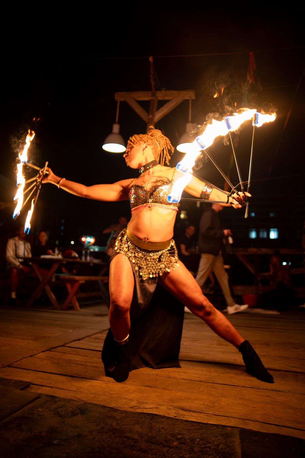 Fire performance at night with city lights behind