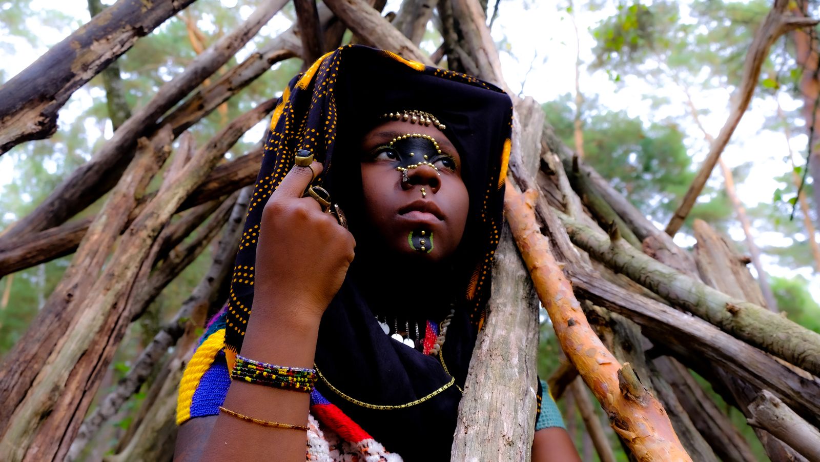 Forest portrait in a wax-print headwrap with beaded face jewellery