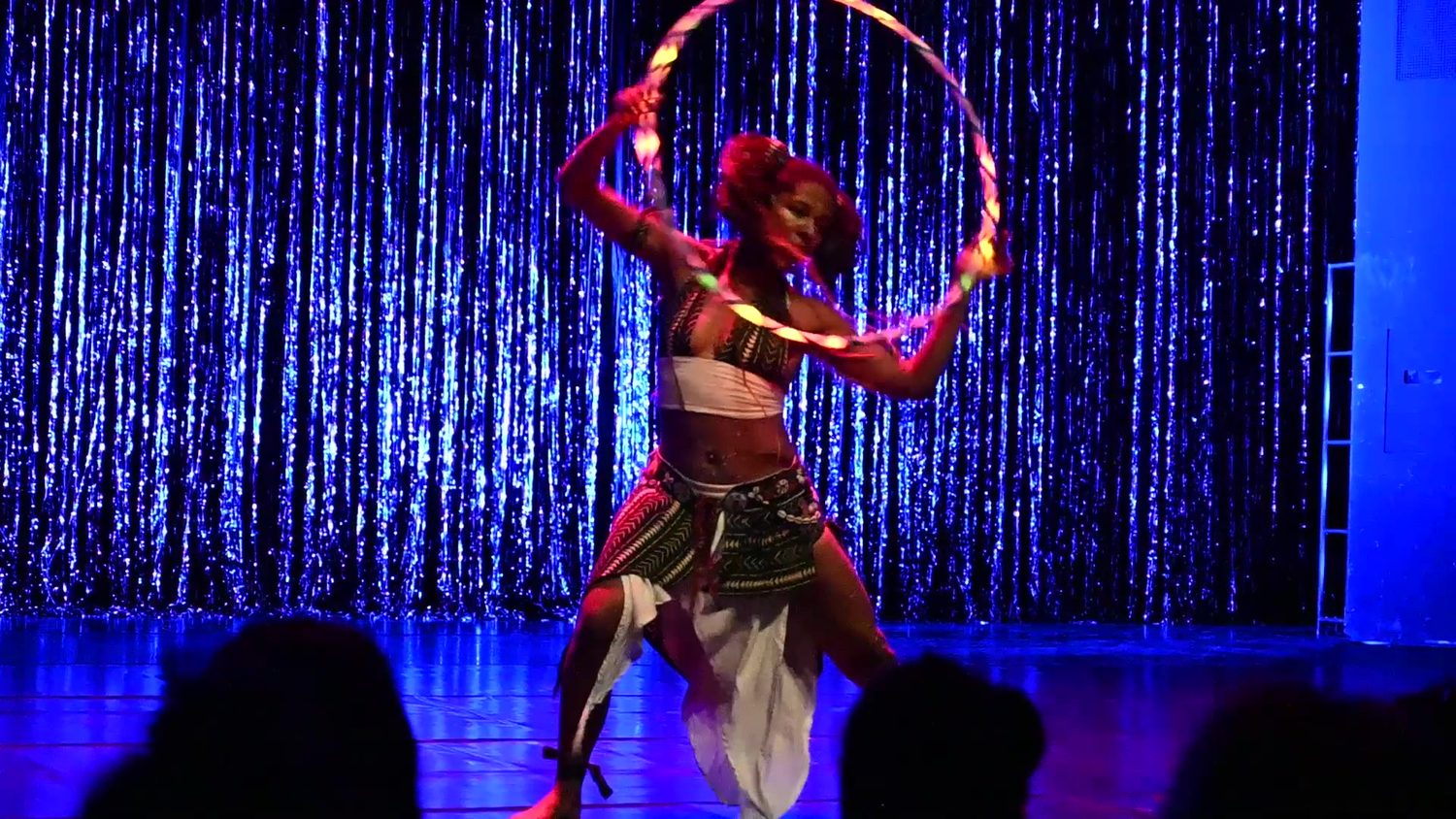 Shida performing a hoop routine on stage before a live audience