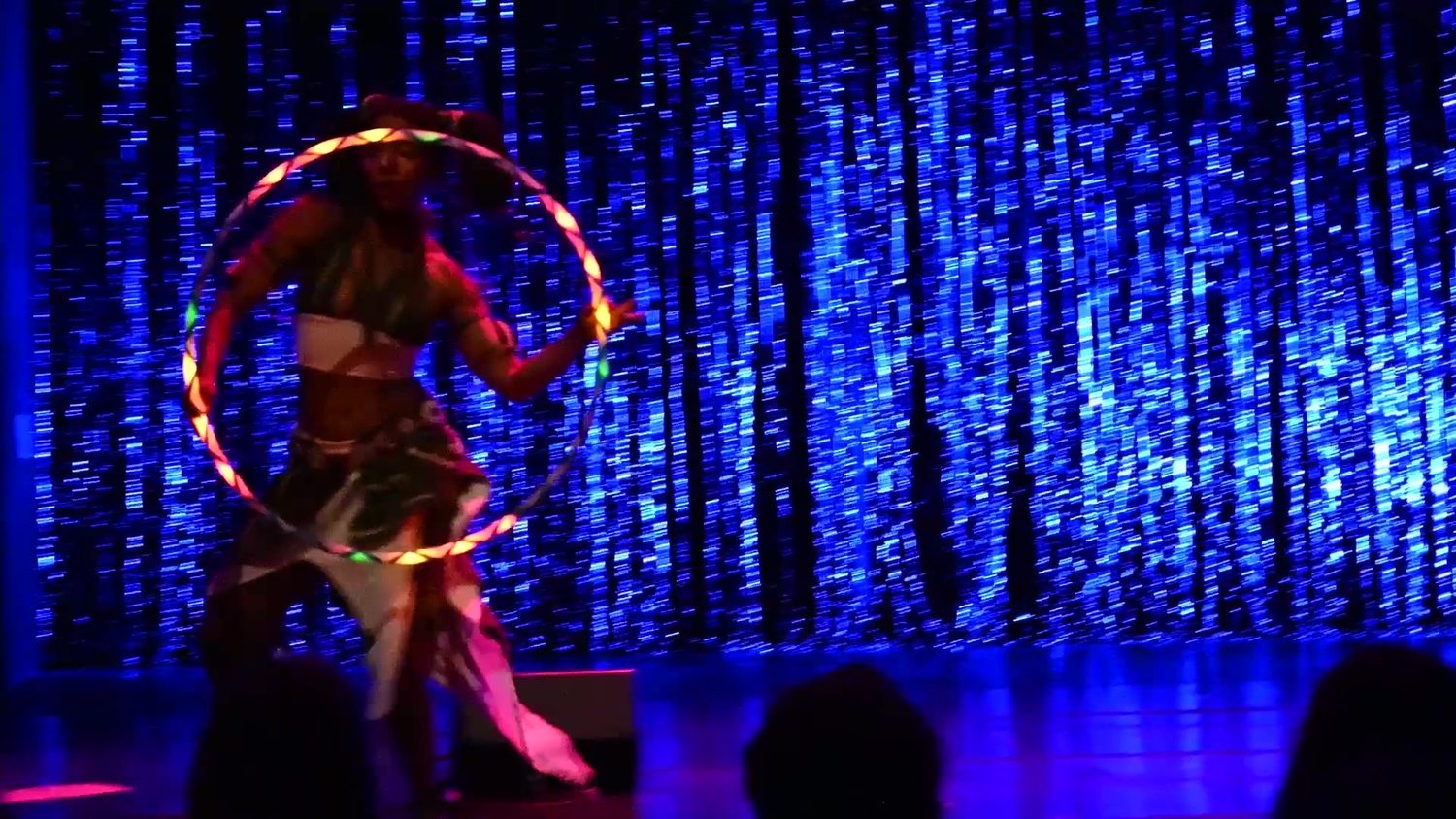 Hoop spinning around the body under red and blue stage light