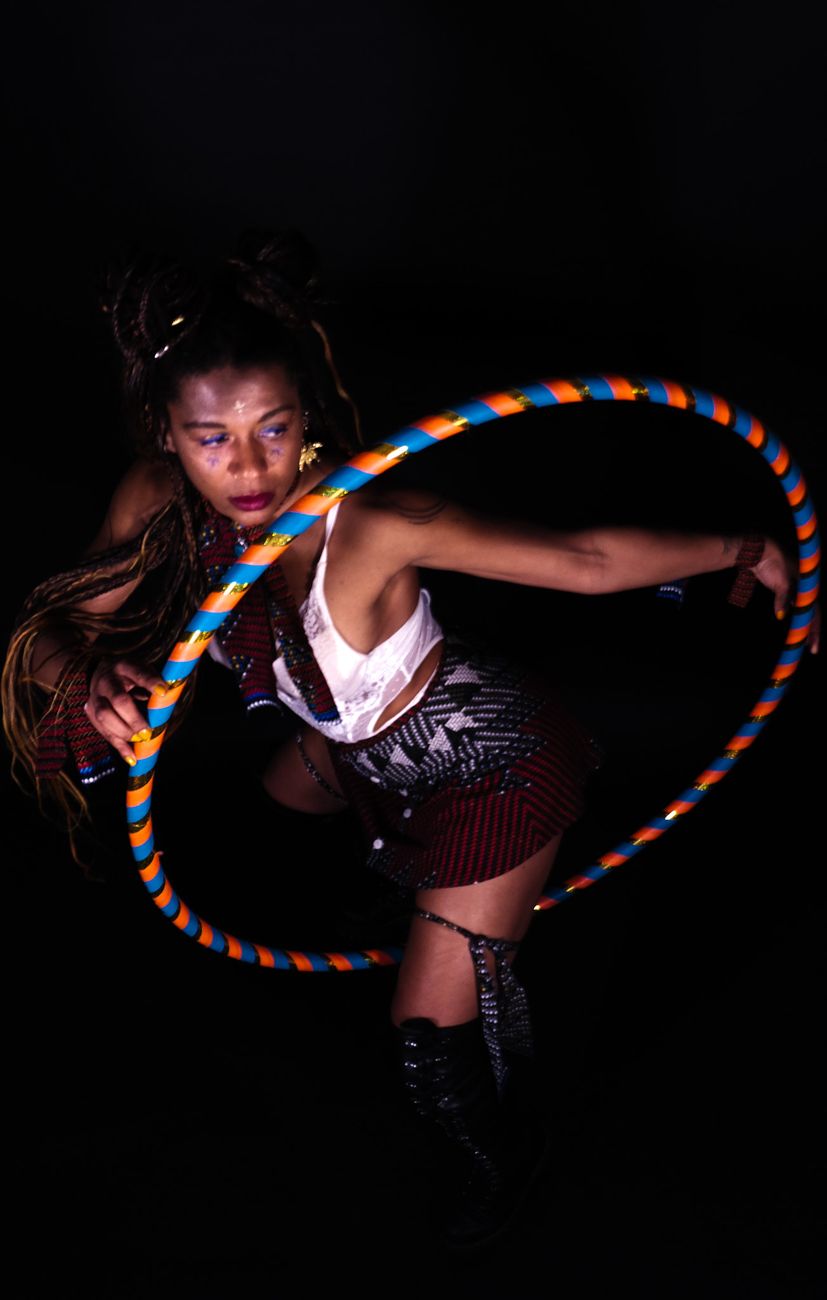 Hoop performance pose against a black background