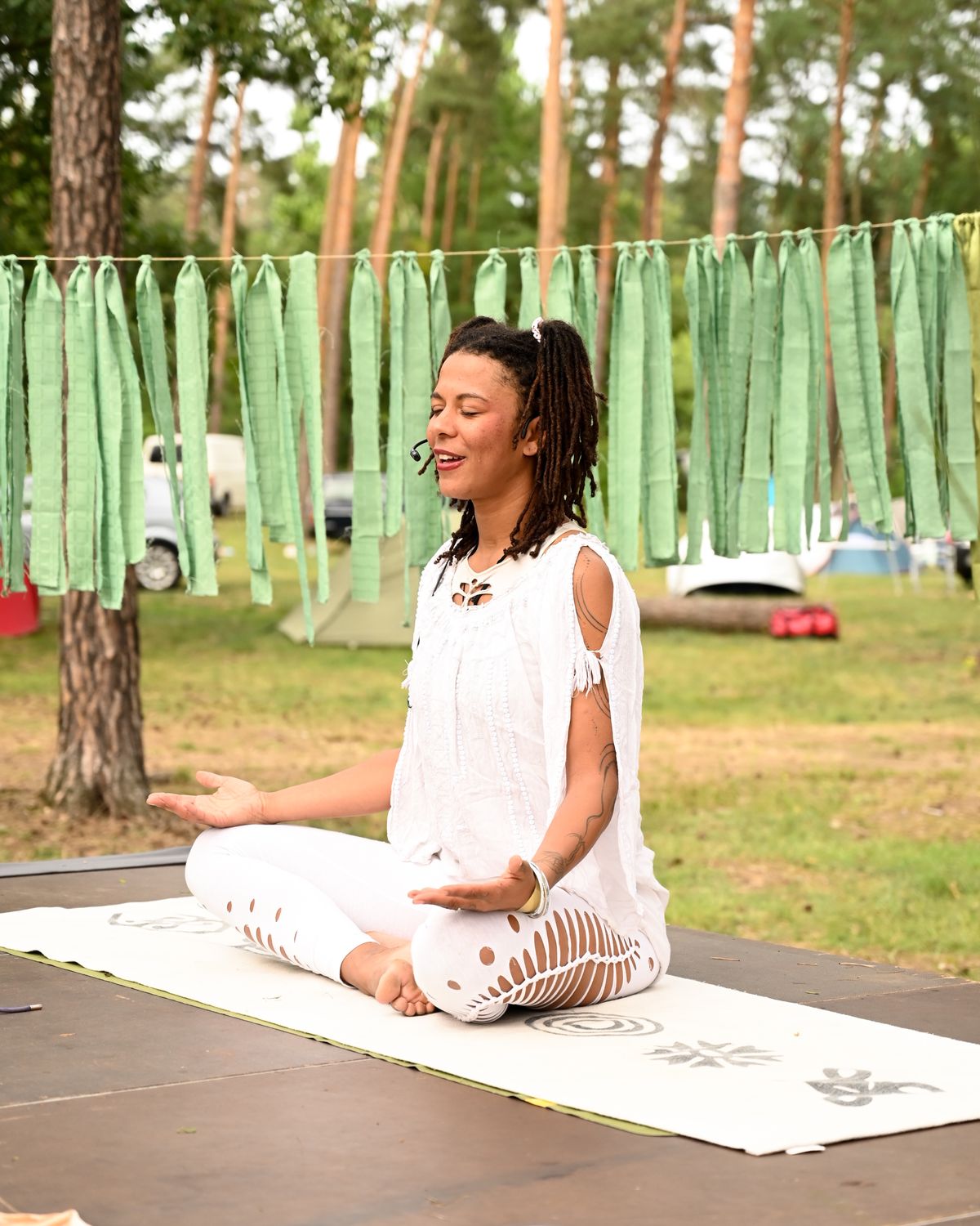 Shida leading a yoga and meditation session at an outdoor festival